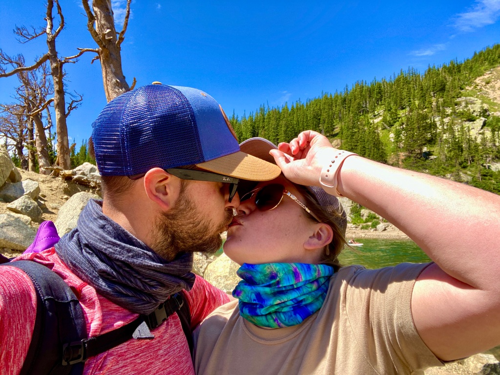 Husband and wife take selfie while kissing